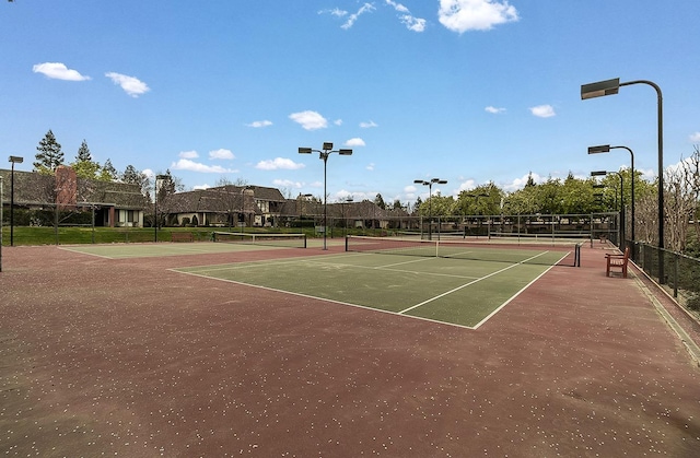 view of sport court featuring fence