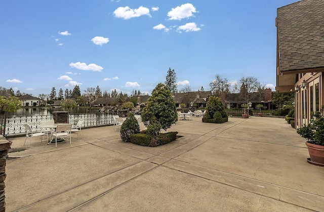 view of patio featuring a residential view and fence