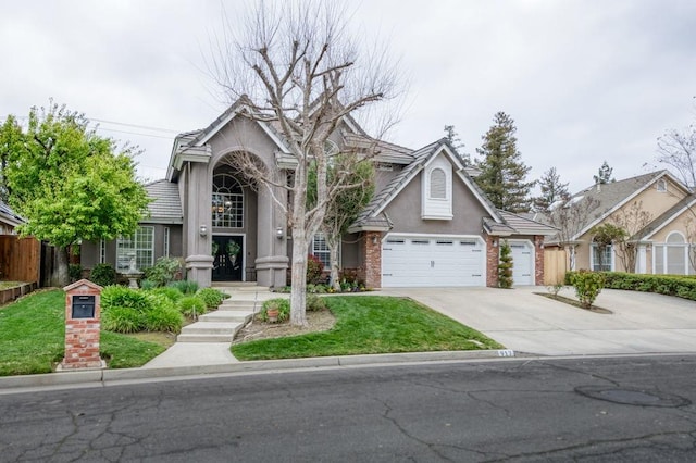 view of front of home with concrete driveway, stucco siding, an attached garage, fence, and brick siding