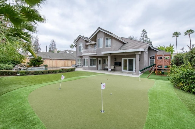 exterior space featuring a patio, a yard, a playground, and fence