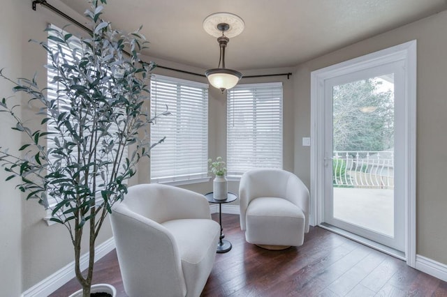 living area with dark wood-style floors and baseboards