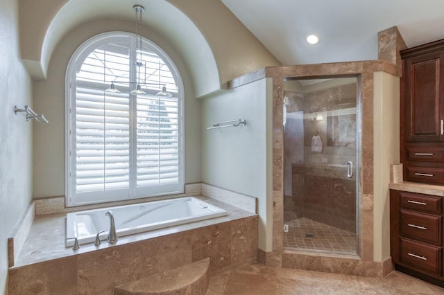 bathroom with a stall shower, a wealth of natural light, and a bath