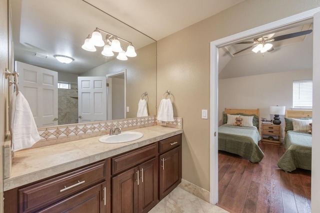 full bathroom with decorative backsplash, a ceiling fan, wood finished floors, ensuite bathroom, and vanity