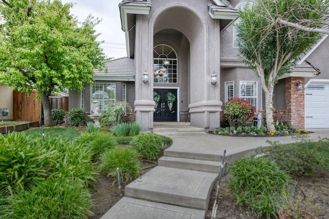 property entrance featuring french doors and stucco siding