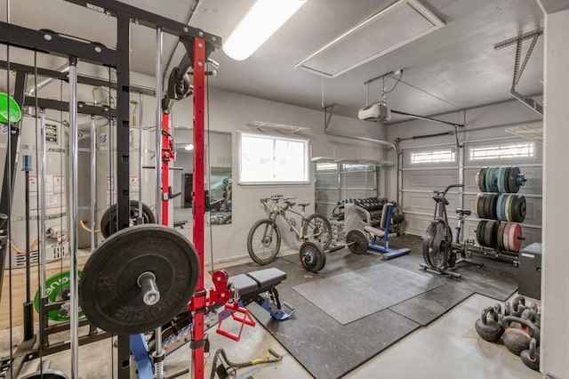 workout room with a garage and attic access