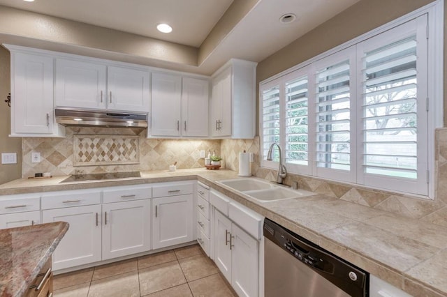 kitchen featuring under cabinet range hood, white cabinetry, light countertops, and dishwasher