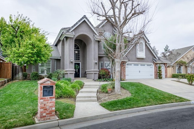 view of front of property featuring stucco siding, concrete driveway, a front yard, fence, and a garage