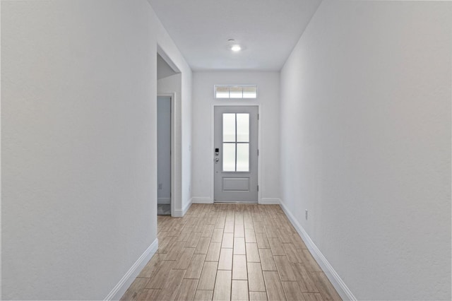 entryway featuring baseboards and light wood-style floors