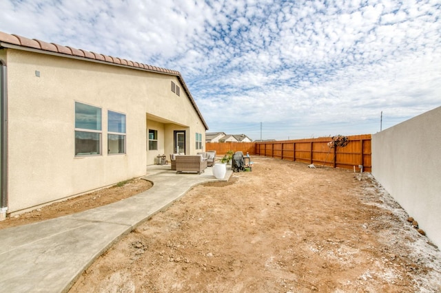 6375 E Millie Dr, Fresno, CA 93727 - fenced backyard with an outdoor living space and a patio