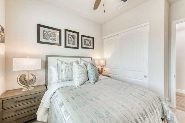 6375 E Millie Dr, Fresno, CA 93727 - bedroom with a closet, a ceiling fan, wood finished floors, and baseboards