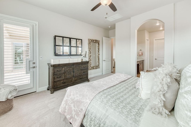 6375 E Millie Dr, Fresno, CA 93727 - carpeted bedroom featuring arched walkways, connected bathroom, baseboards, and a ceiling fan