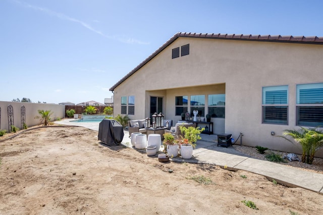 6375 E Millie Dr, Fresno, CA 93727 - back of property featuring a fenced backyard, stucco siding, and a patio