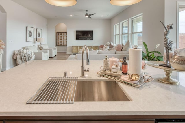6375 E Millie Dr, Fresno, CA 93727 - kitchen with a sink, arched walkways, open floor plan, a ceiling fan, and recessed lighting