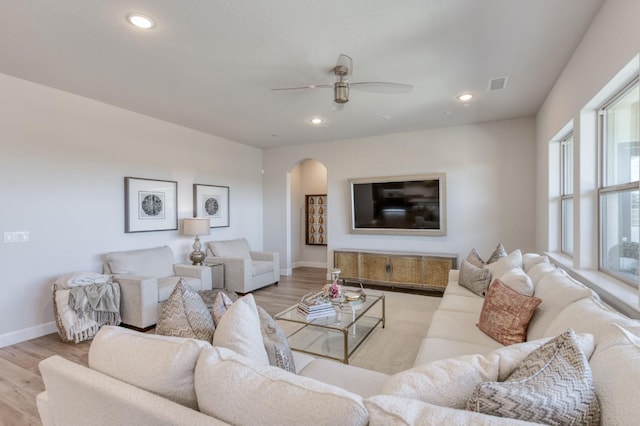 6375 E Millie Dr, Fresno, CA 93727 - living room featuring arched walkways, wood finished floors, baseboards, a ceiling fan, and recessed lighting