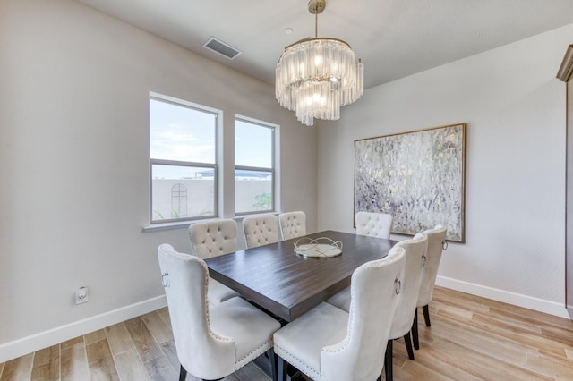 6375 E Millie Dr, Fresno, CA 93727 - dining area with a chandelier, baseboards, and light wood-style floors