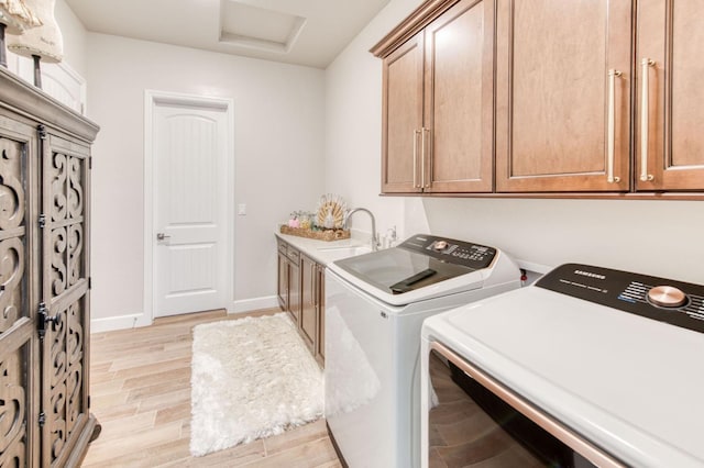 6375 E Millie Dr, Fresno, CA 93727 - laundry room featuring cabinet space, independent washer and dryer, light wood-type flooring, baseboards, and attic access