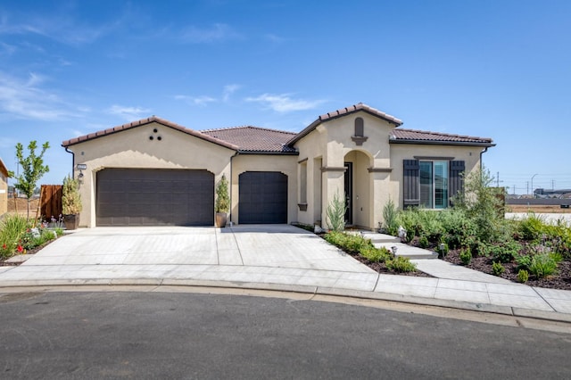 6375 E Millie Dr, Fresno, CA 93727 - mediterranean / spanish home with a garage, stucco siding, driveway, and a tiled roof