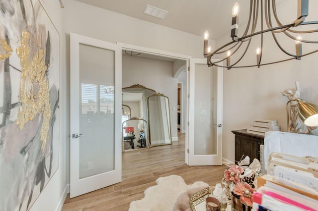 6375 E Millie Dr, Fresno, CA 93727 - sitting room featuring french doors, arched walkways, a chandelier, light wood finished floors, and baseboards
