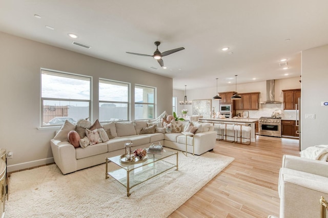 living room featuring recessed lighting, visible vents, light wood-style floors, ceiling fan, and baseboards