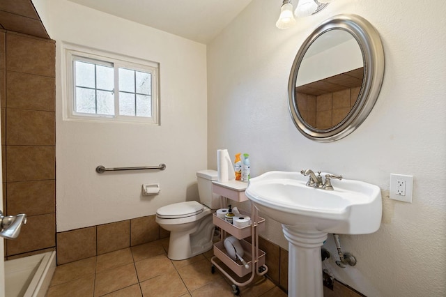 bathroom featuring toilet and tile patterned floors