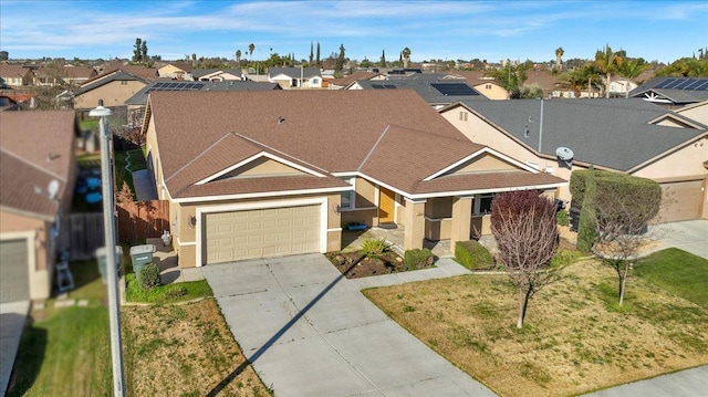 ranch-style house featuring driveway, a garage, a residential view, a front lawn, and stucco siding