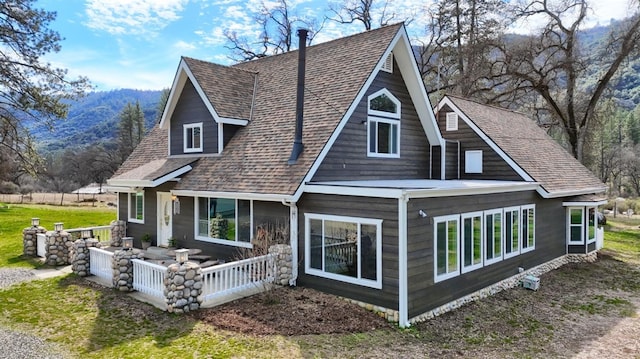 back of property with a shingled roof