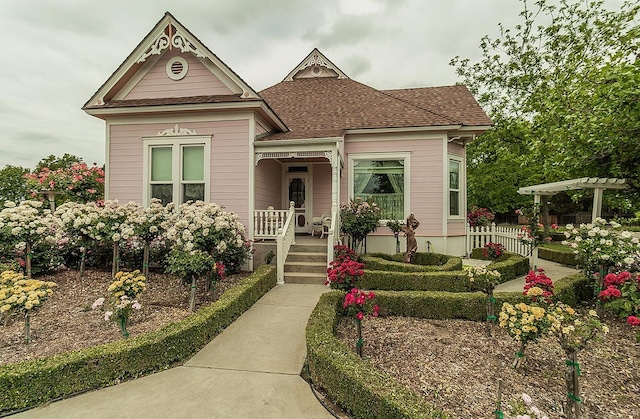 victorian-style house with a porch and a shingled roof