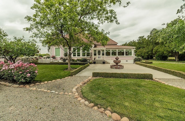 exterior space featuring fence and a front lawn