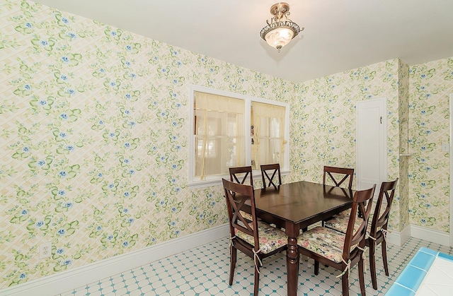 dining space with tile patterned flooring, baseboards, and wallpapered walls