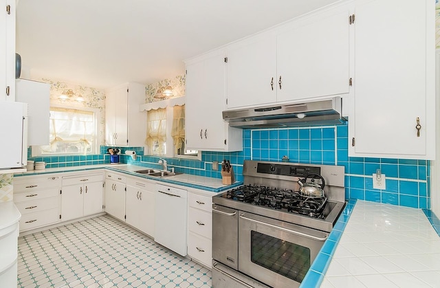 kitchen featuring white cabinets, white dishwasher, backsplash, double oven range, and under cabinet range hood
