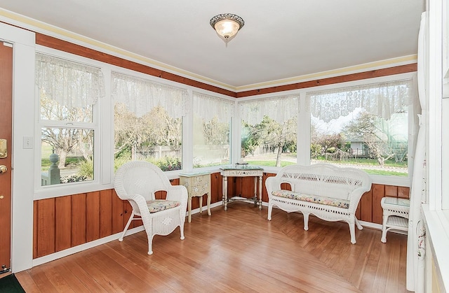 sunroom / solarium with wood finished floors and a wealth of natural light