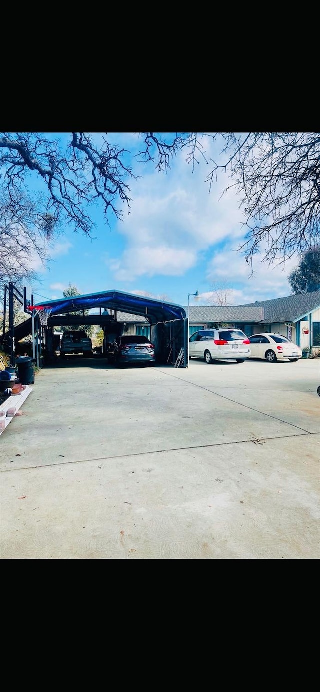 view of parking / parking lot with a carport