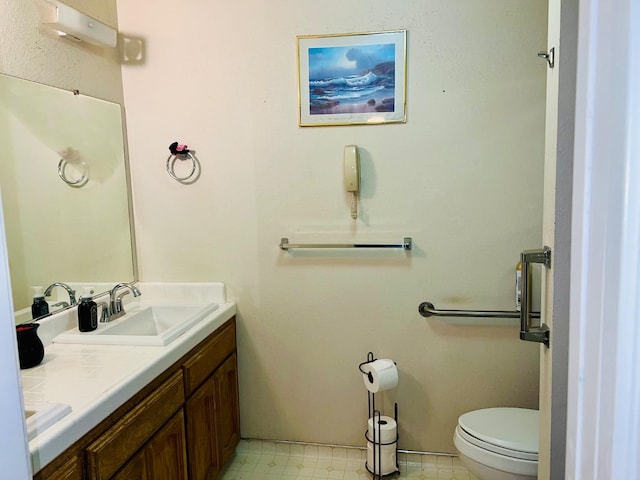 bathroom with vanity, toilet, and tile patterned floors