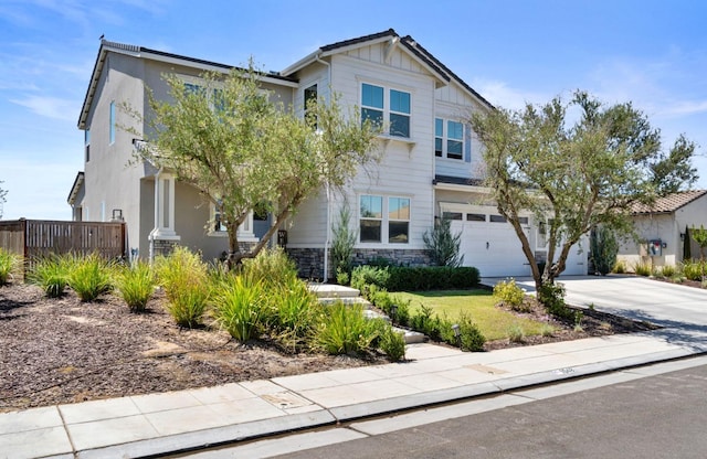 1048 Sawtooth Way S, Madera, CA 93636 - craftsman house featuring fence, concrete driveway, a garage, and stone siding