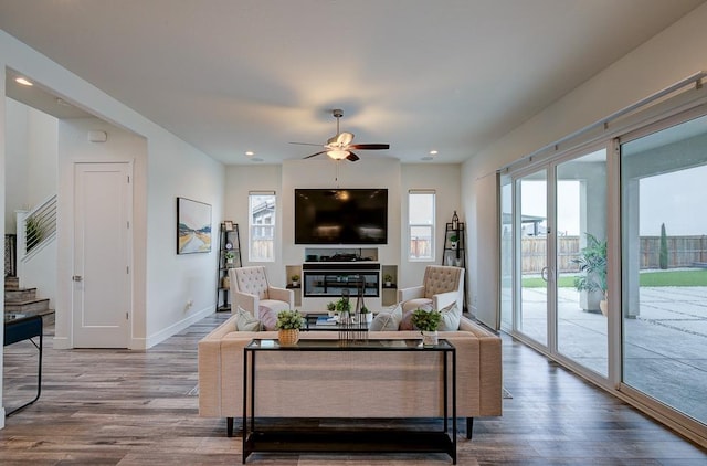 1048 Sawtooth Way S, Madera, CA 93636 - living room featuring wood finished floors, a ceiling fan, baseboards, stairs, and recessed lighting