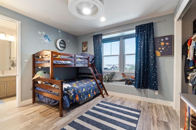 1048 Sawtooth Way S, Madera, CA 93636 - bedroom with light wood-style floors, ensuite bathroom, and baseboards