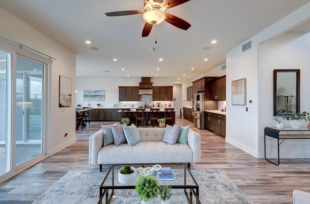 1048 Sawtooth Way S, Madera, CA 93636 - living area with baseboards, light wood finished floors, a ceiling fan, and recessed lighting