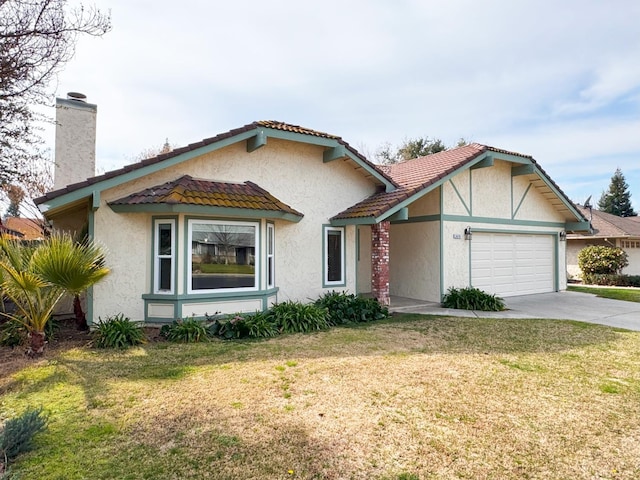 view of front of home with an attached garage, stucco siding, driveway, and a front yard