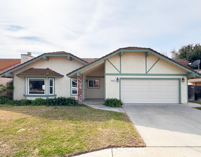 view of front of home with concrete driveway, an attached garage, a front lawn, and stucco siding