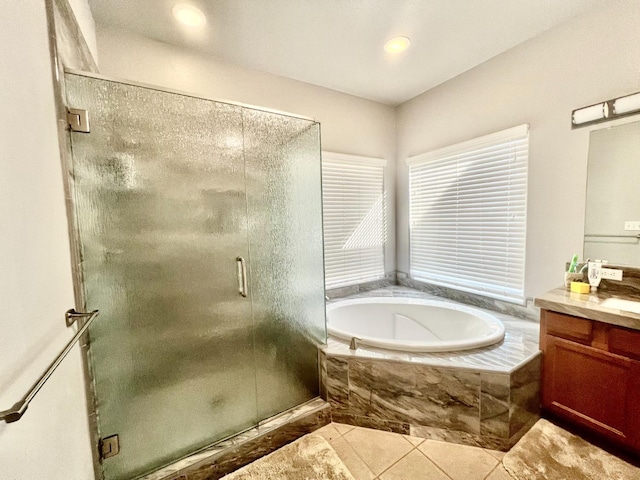 bathroom with tile patterned flooring, a shower stall, a bath, and vanity