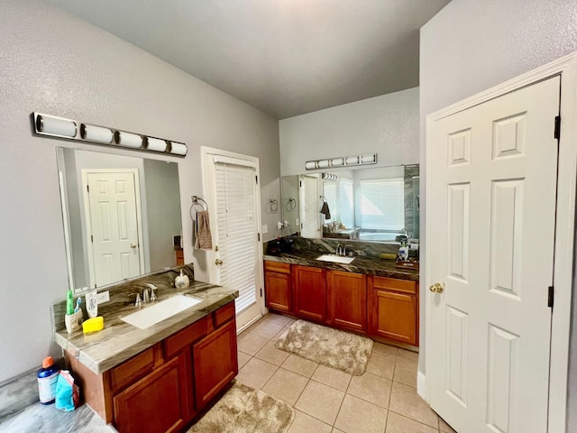 bathroom with two vanities, tile patterned flooring, and a sink