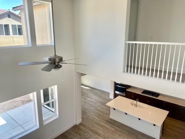 interior details featuring a ceiling fan and wood finished floors