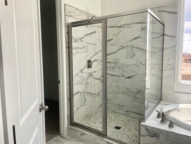 full bathroom with a bath, a marble finish shower, and marble finish floor