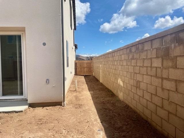 view of property exterior featuring a fenced backyard and stucco siding