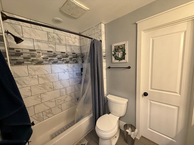 bathroom featuring a textured ceiling, toilet, and shower / tub combo with curtain