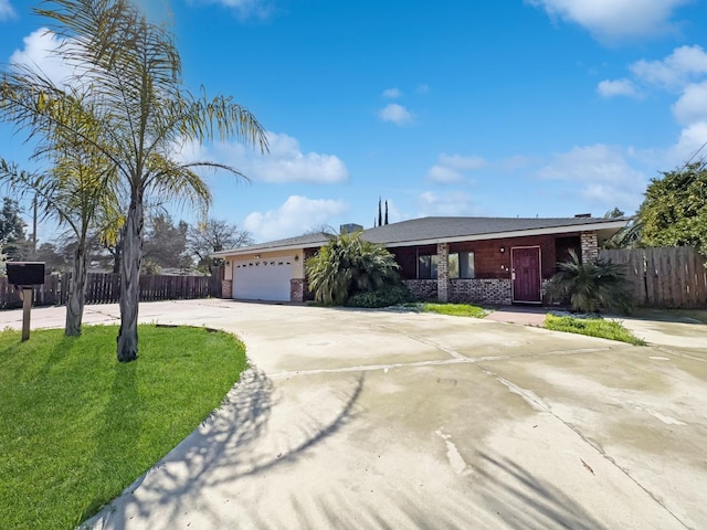 ranch-style house with an attached garage, driveway, a front lawn, and fence