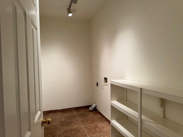 clothes washing area featuring laundry area, washer hookup, electric dryer hookup, and baseboards