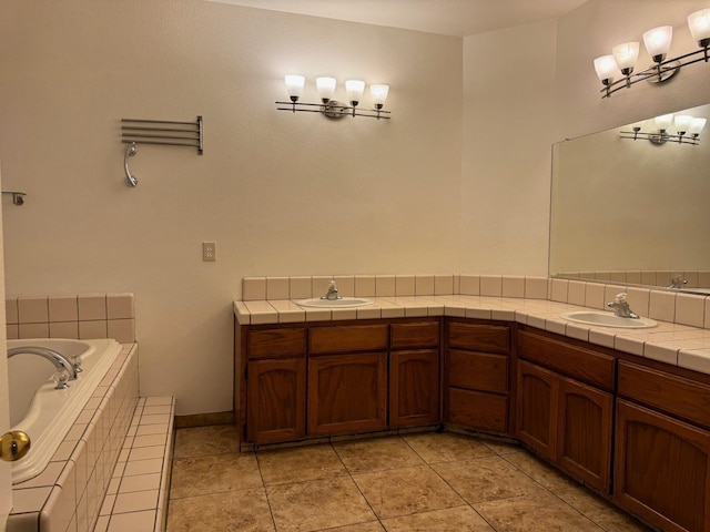 full bathroom featuring double vanity, tiled bath, tile patterned flooring, and a sink