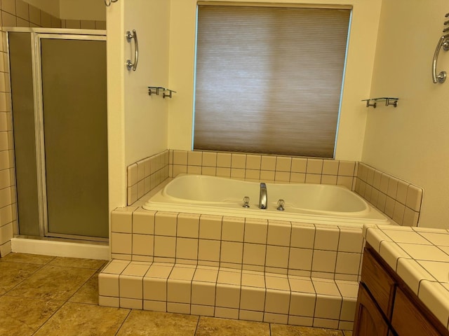 bathroom with tile patterned flooring, a shower stall, vanity, and a bath