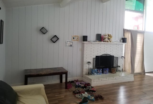 living area with a fireplace and wood finished floors